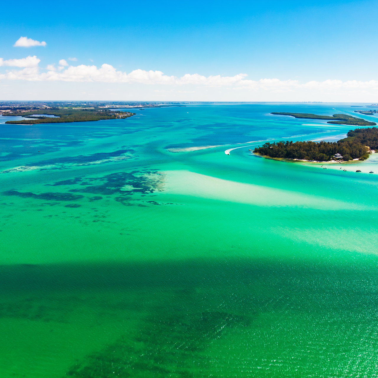 Green and blue sea with sand islands